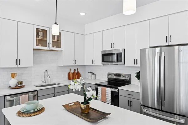 a kitchen with stainless steel appliances a sink a stove and refrigerator