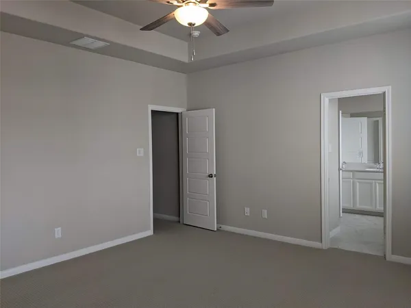 an empty room with a fan and a ceiling fan
