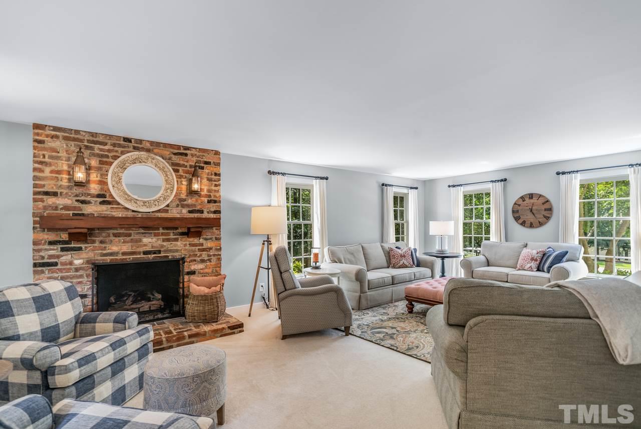 301 Pasture Lane Raleigh, NC 27614 - Photo 8 of 29 a living room with furniture a fireplace and a large window