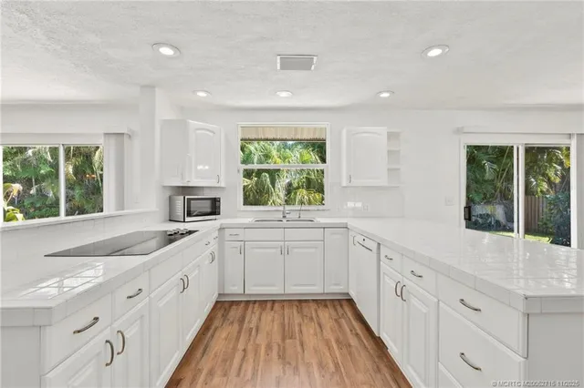 a kitchen with sink cabinets and wooden floor