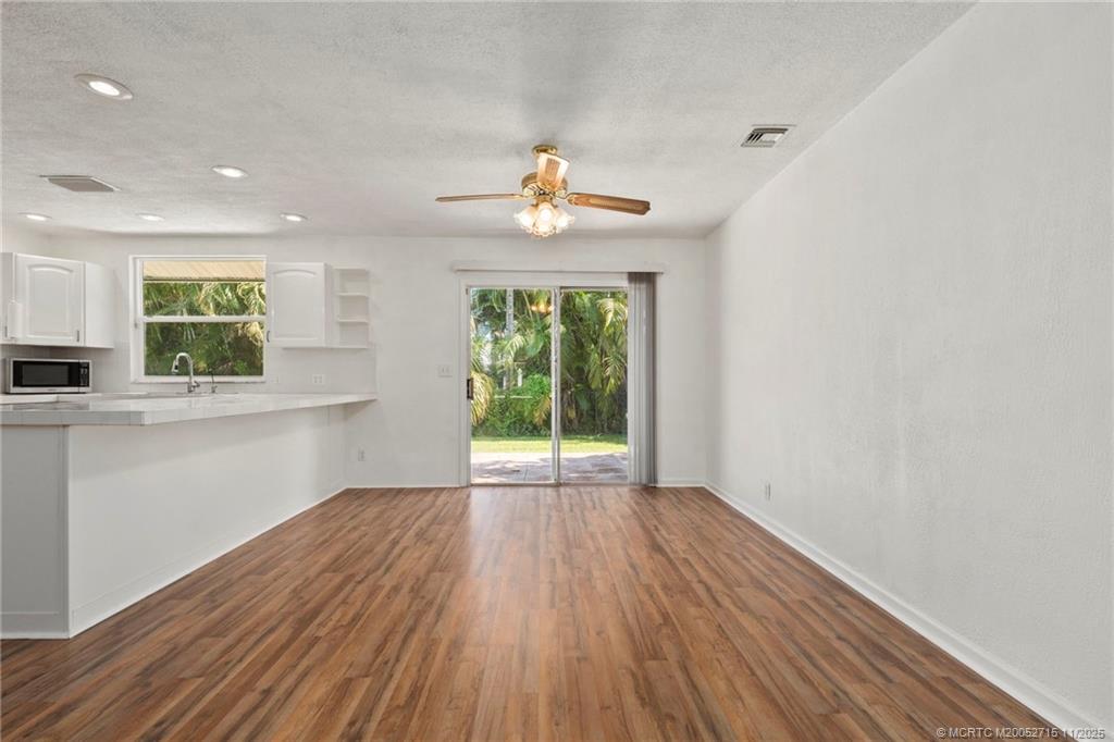 5801 Southeast Cable Drive Stuart, FL 34997 - Photo 15 of 48 a view of an empty room with a window and wooden floor