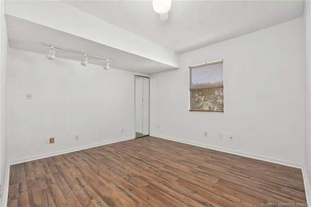 a view of room with window and wooden floor