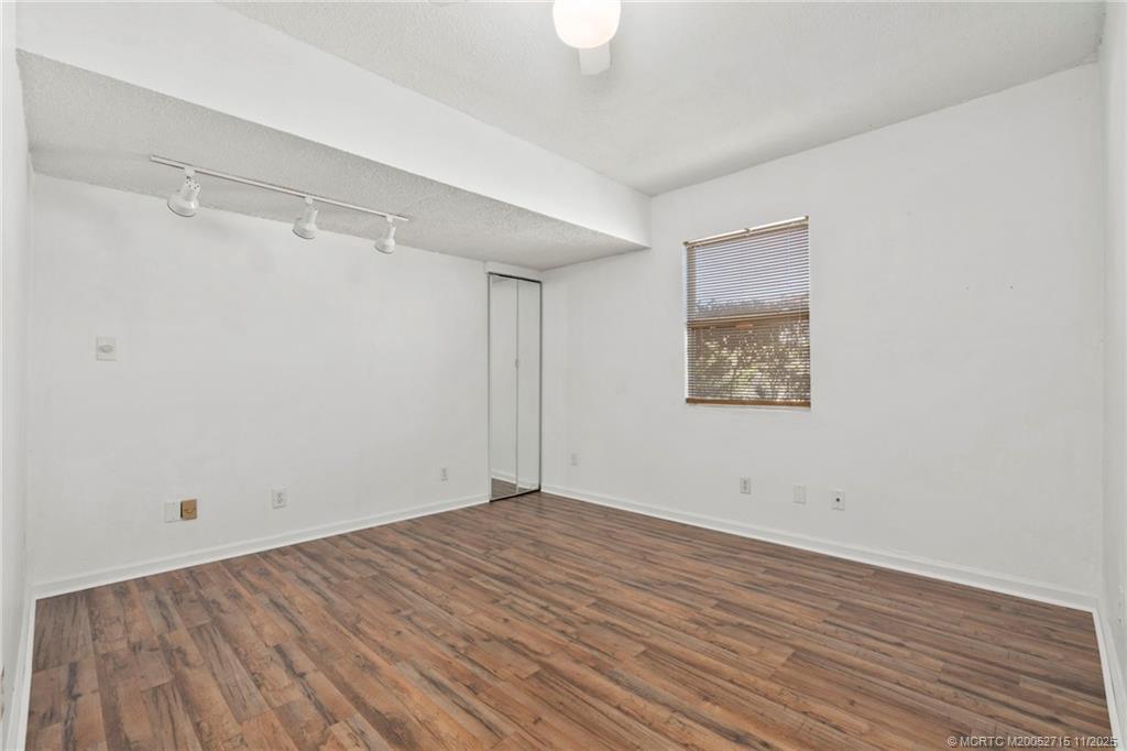 5801 Southeast Cable Drive Stuart, FL 34997 - Photo 22 of 48 a view of a room with wooden floor and white walls
