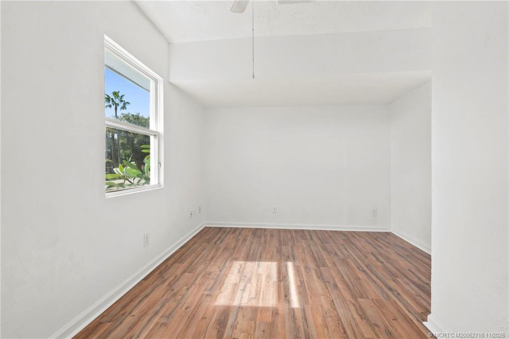 5801 Southeast Cable Drive Stuart, FL 34997 - Photo 23 of 48 a view of room with window and wooden floor