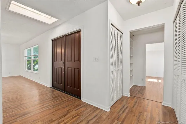 wooden floor in an empty room with a window