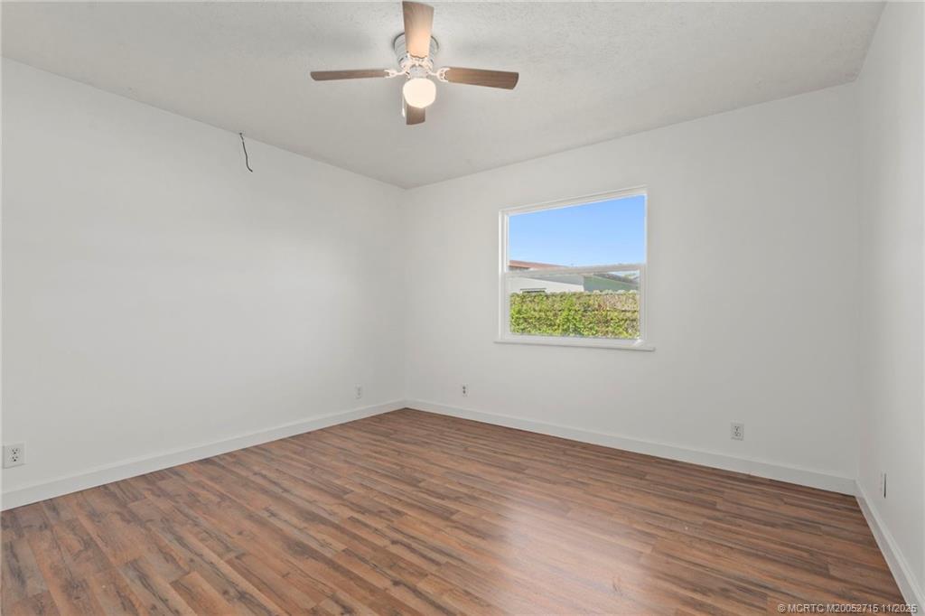 5801 Southeast Cable Drive Stuart, FL 34997 - Photo 27 of 48 wooden floor in an empty room with a window