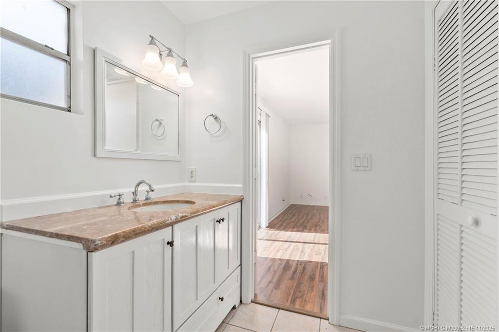 5801 Southeast Cable Drive Stuart, FL 34997 - Photo 32 of 48 a bathroom with a granite countertop sink and a mirror