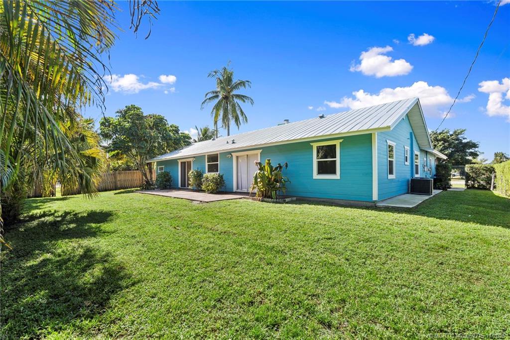 5801 Southeast Cable Drive Stuart, FL 34997 - Photo 38 of 48 a front view of house with yard and green space