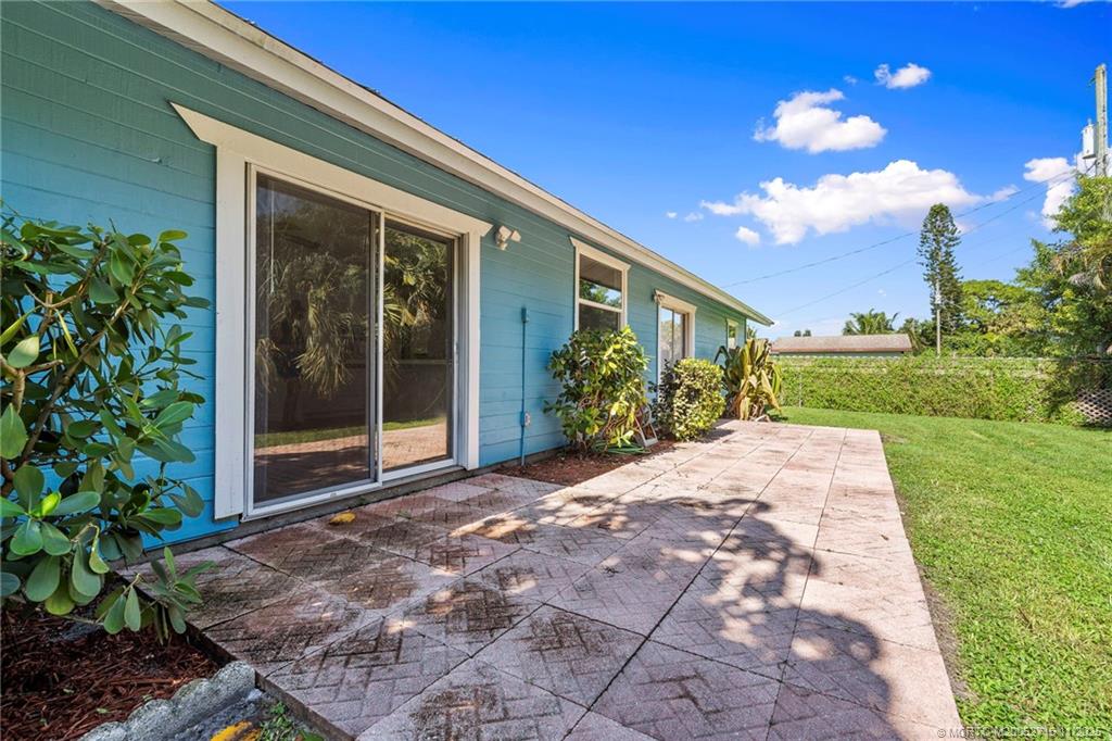5801 Southeast Cable Drive Stuart, FL 34997 - Photo 39 of 48 a front view of a house with a yard