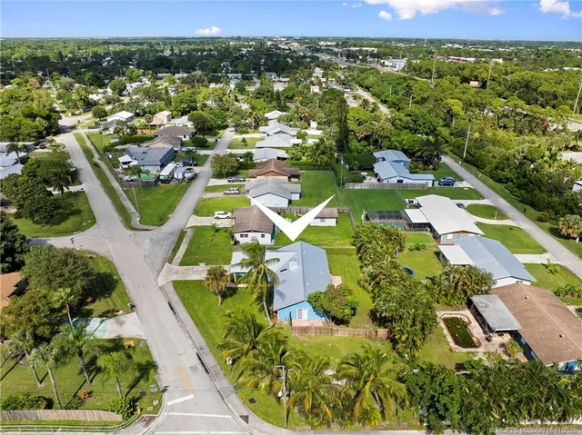 an aerial view of a house with a garden and swimming pool