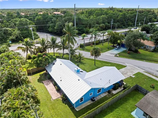 an aerial view of a house with a yard basket ball court and outdoor seating