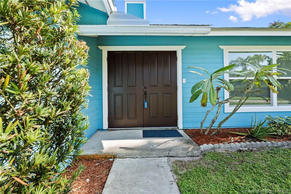 5801 Southeast Cable Drive Stuart, FL 34997 - Photo 5 of 48 a front view of a house with garden