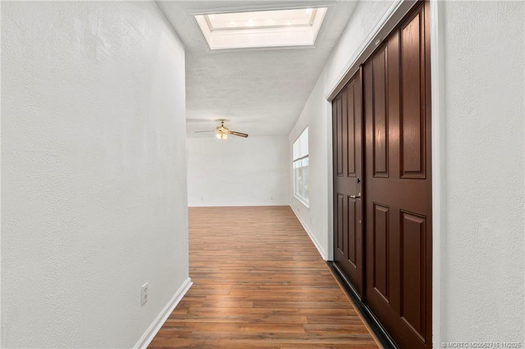 5801 Southeast Cable Drive Stuart, FL 34997 - Photo 6 of 48 a view of a hallway with wooden floor