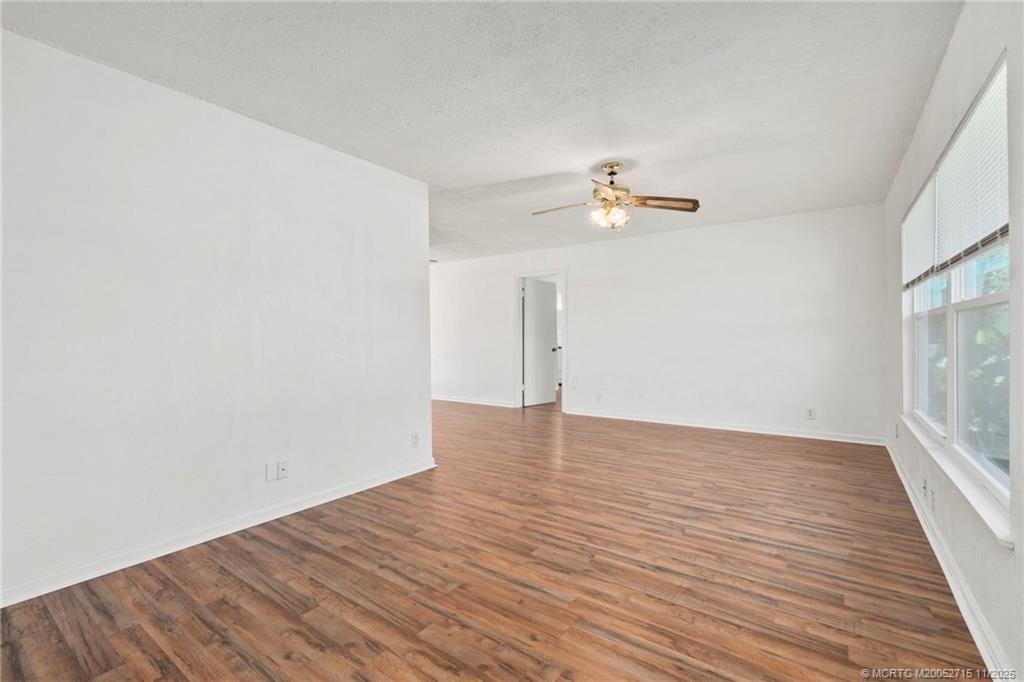 5801 Southeast Cable Drive Stuart, FL 34997 - Photo 8 of 48 wooden floor in an empty room with a window
