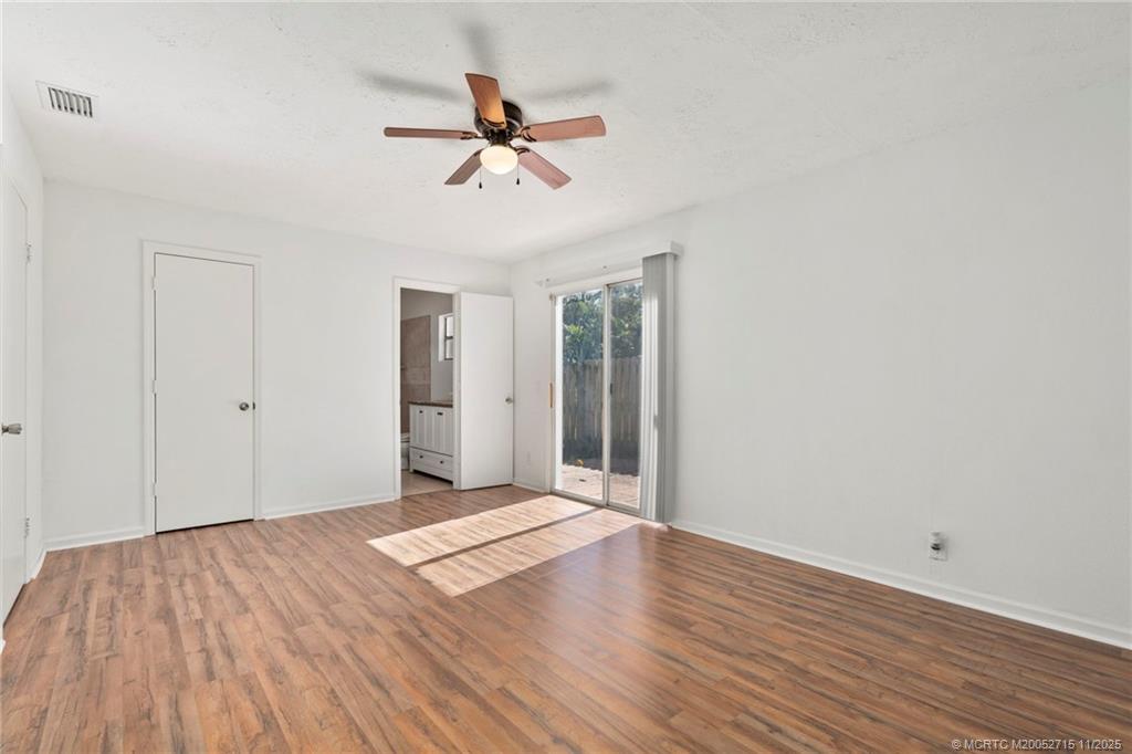 5801 Southeast Cable Drive Stuart, FL 34997 - Photo 10 of 48 a view of a room with wooden floor and ceiling fan