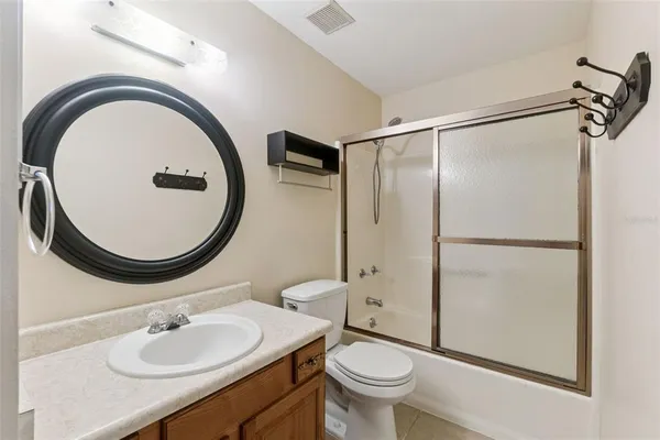a bathroom with a sink toilet and a mirror