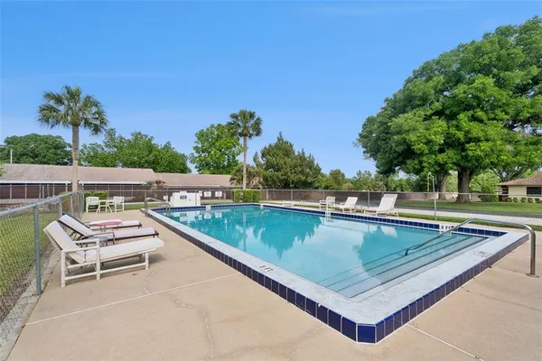 swimming pool view with a seating space