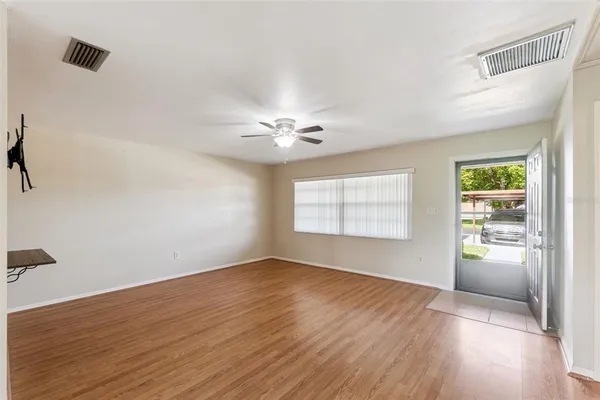 wooden floor in an empty room with a window
