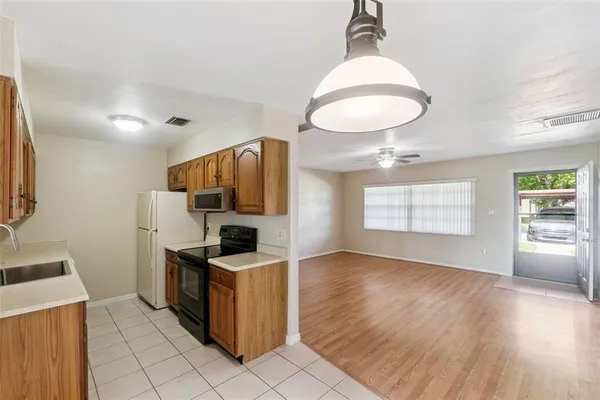 a kitchen with granite countertop a stove and a sink