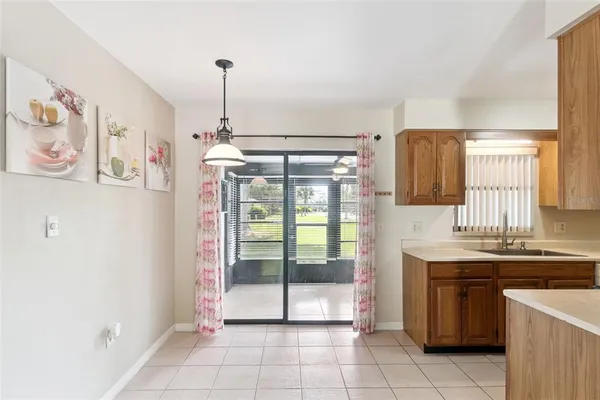 a spacious bathroom with a sink a mirror and next to a window