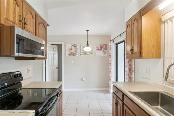 a kitchen with stainless steel appliances granite countertop a refrigerator and a stove top oven
