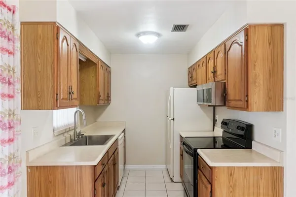 a kitchen with stainless steel appliances a sink stove and refrigerator