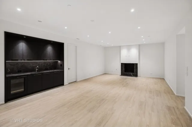 a view of kitchen with a sink and refrigerator