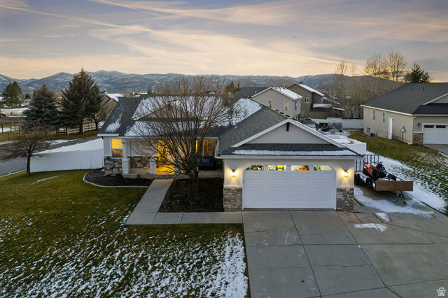 5167 Rodeo Circle, Unit 6 Oakley, UT 84055 - Photo 1 of 1 View of front of property with stone siding, stucco siding, driveway, a mountain view, and a garage