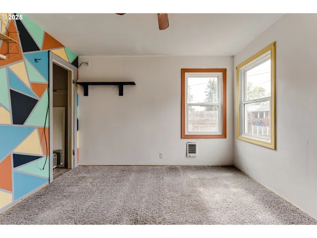 a view of an empty room with windows