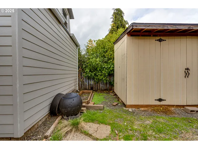 a view of an empty room with a window and fireplace