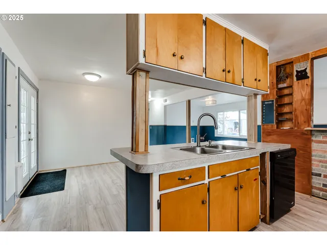 a kitchen with kitchen island a sink stainless steel appliances and cabinets