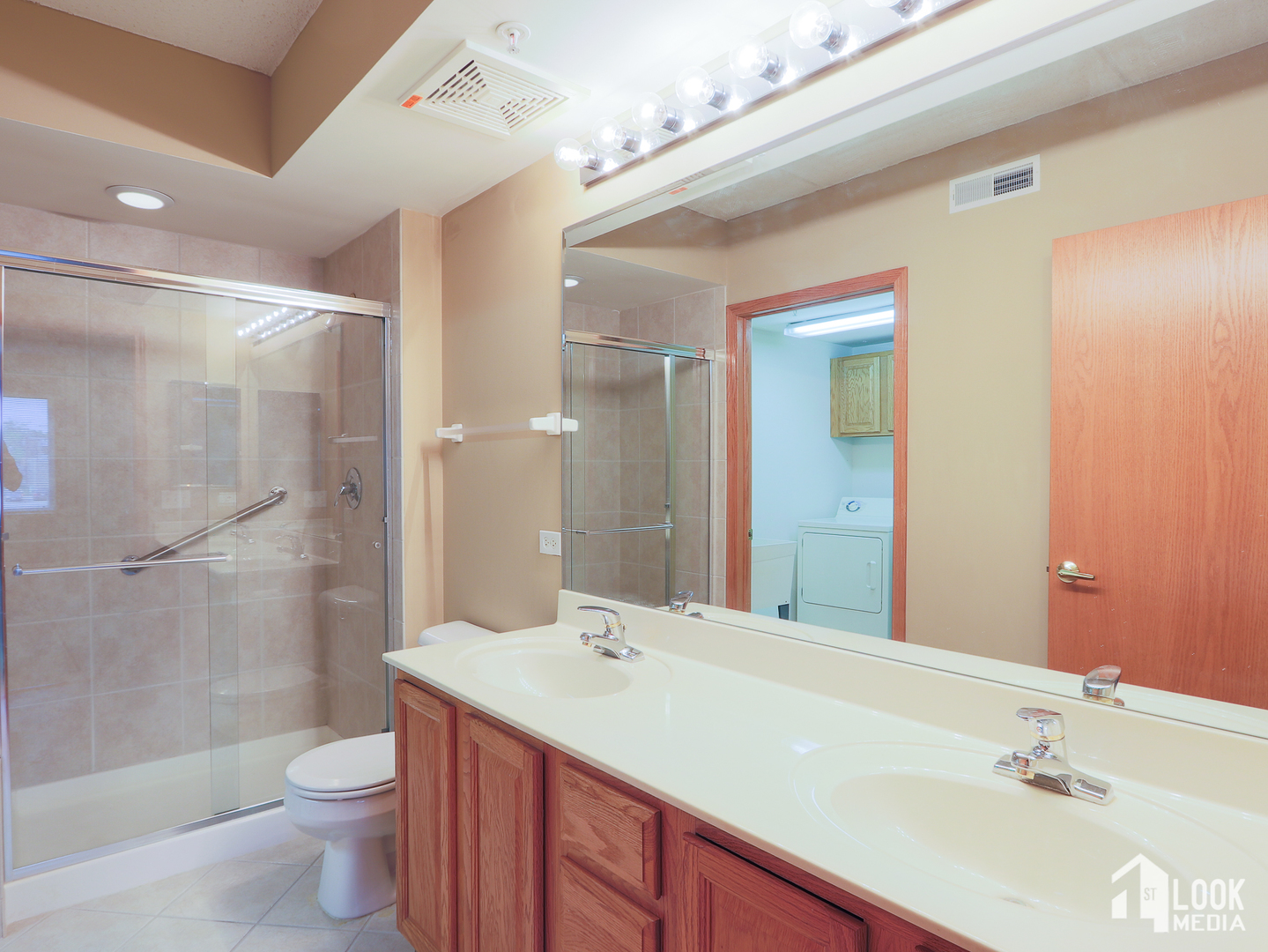 5 West Central Road, Unit 207 Mount Prospect, IL 60056 - Photo 12 of 29 a bathroom with a sink a toilet a shower and a mirror