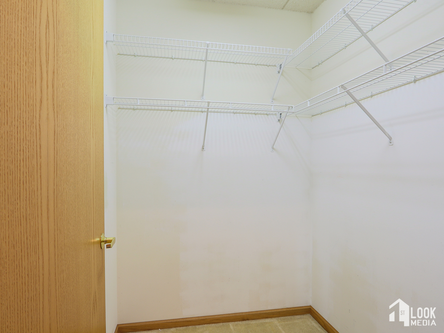 5 West Central Road, Unit 207 Mount Prospect, IL 60056 - Photo 17 of 29 a view of a room with racks on the wall