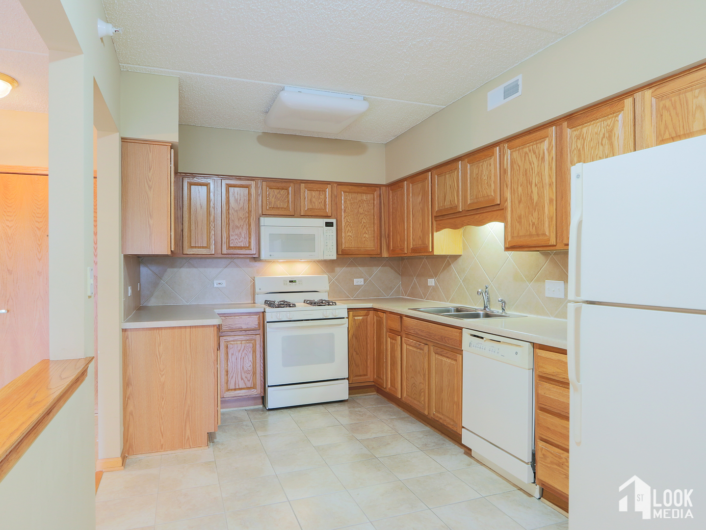 5 West Central Road, Unit 207 Mount Prospect, IL 60056 - Photo 6 of 29 a kitchen with granite countertop a refrigerator stove top oven a sink and dishwasher