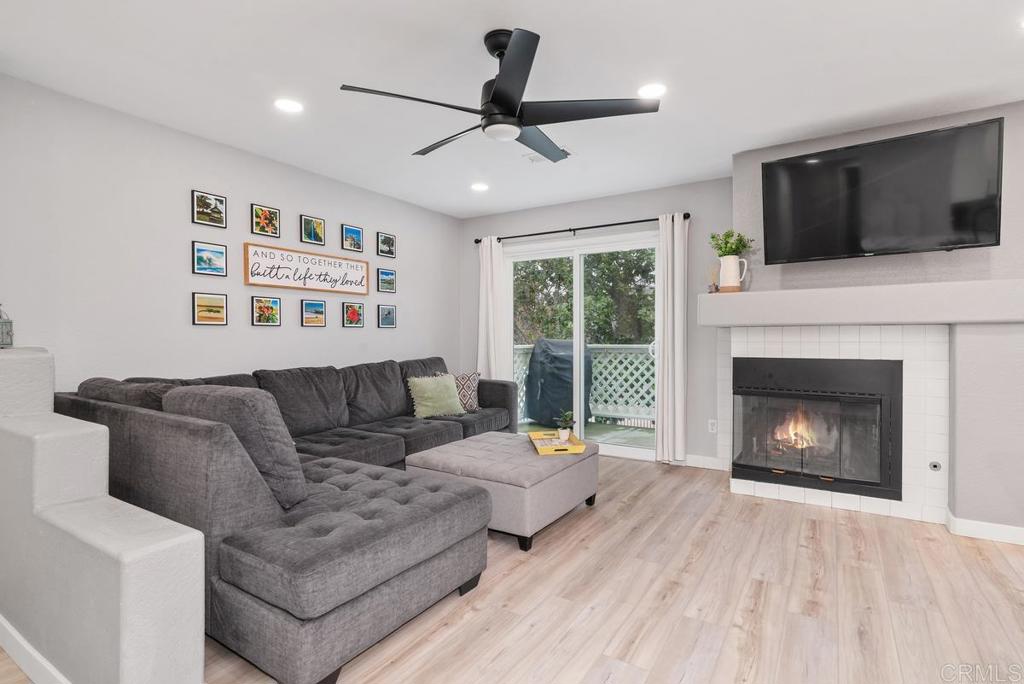 13981 Midland Road Poway, CA 92064 - Photo 3 of 26 a living room with furniture a fireplace and a flat screen tv