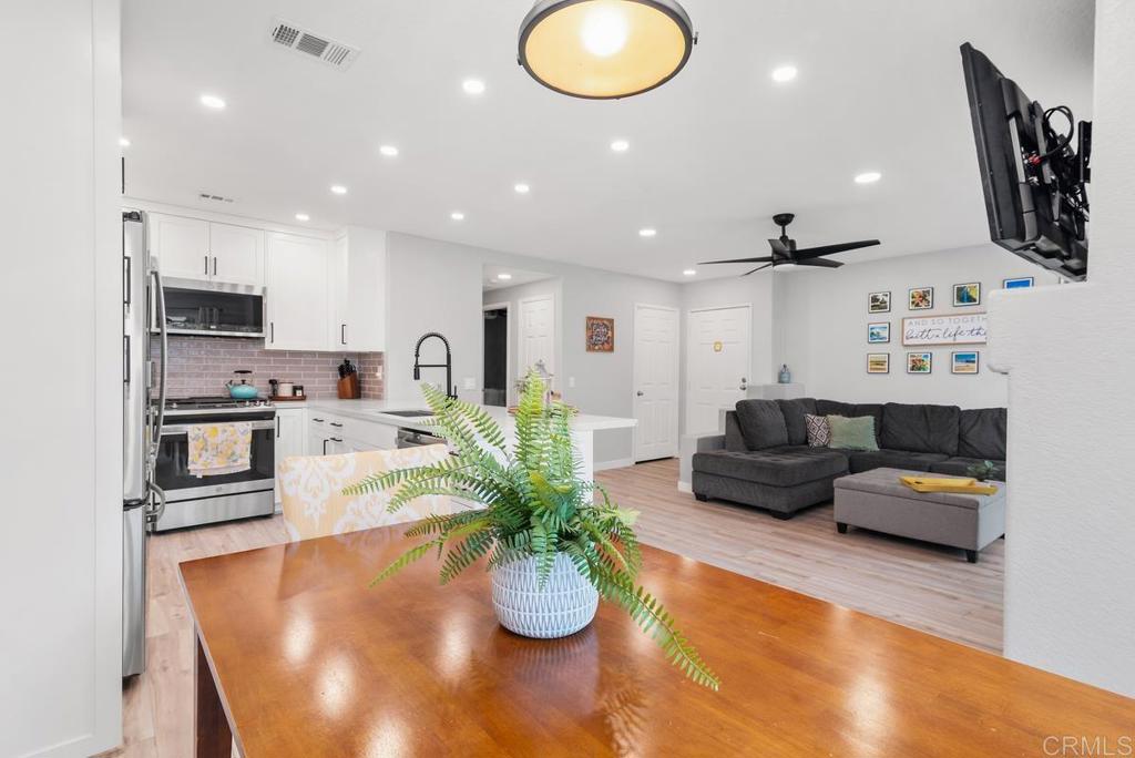 13981 Midland Road Poway, CA 92064 - Photo 8 of 26 a living room with kitchen island furniture and a potted plant