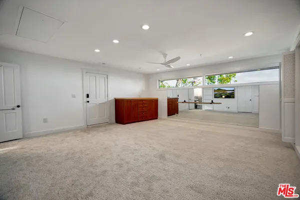 a view of hallway with furniture and wooden floor