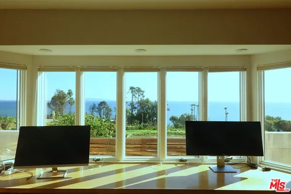 a view of a hallway with a door and stairs