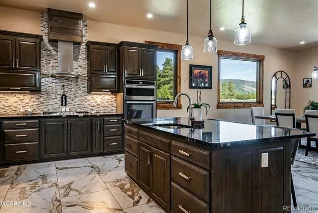 a kitchen with stainless steel appliances a sink stove and refrigerator