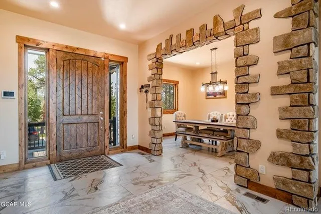 a view of entryway with wooden floor and cabinets