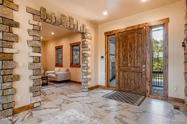 a view of a hallway with entryway door