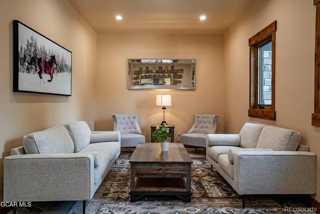 a living room with furniture and a painting