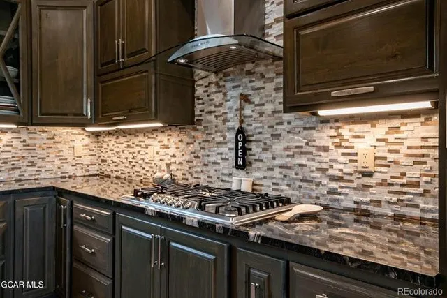 a kitchen with stainless steel appliances granite countertop a stove and a microwave