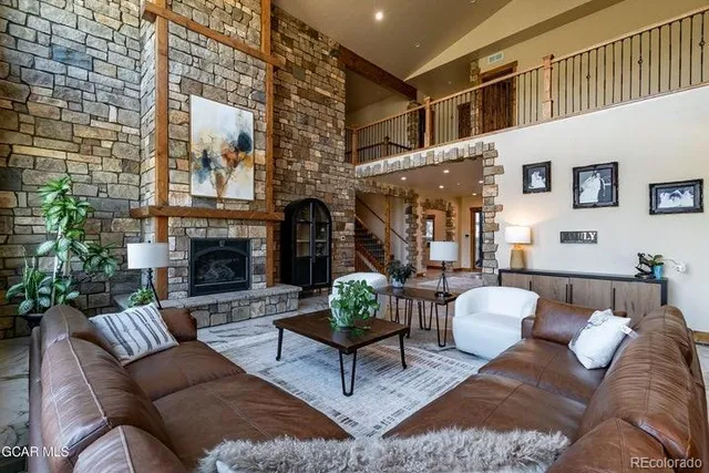 a living room with furniture a fireplace and a table