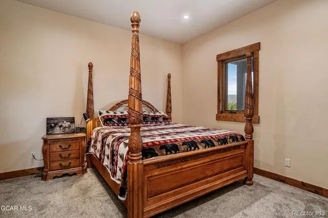 a bed sitting in a room next to a window