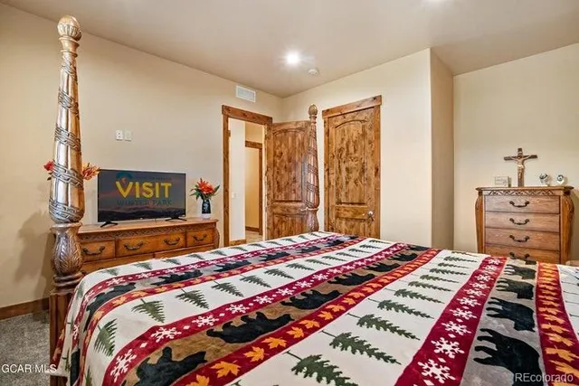 a bedroom with a bed and a flat screen tv