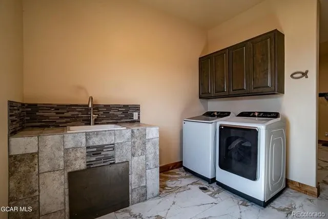 a kitchen with granite countertop a stove and a microwave