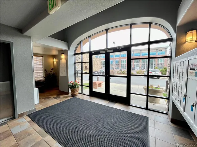 a view of roof deck with couch and chairs
