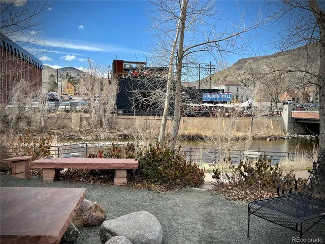 a view of backyard with seating area and trees