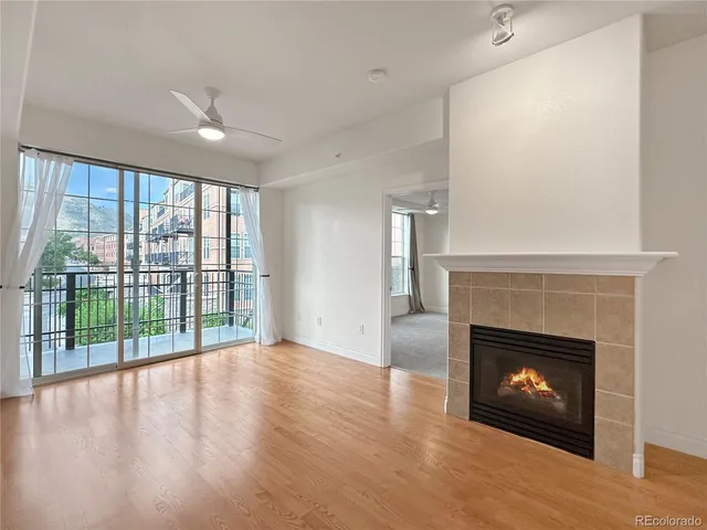 a view of an empty room with a fireplace and a window